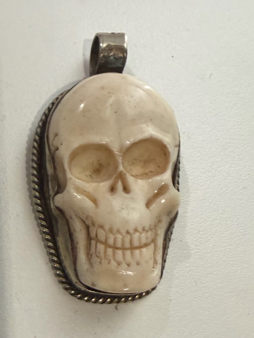 Carved bone skull sterling silver pendant